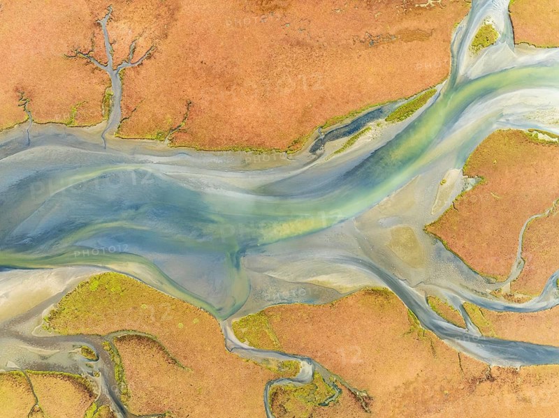 Streams at low tide in the marshland of the Walvis Bay lagoon. Aerial view. Drone shot. Walvis Bay, Namibia