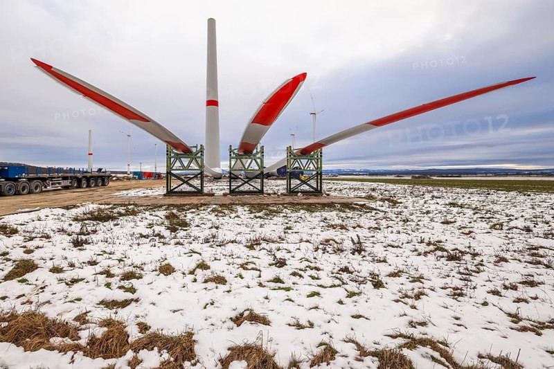 Rotor blades lying in front of the unfinished tower at the Cramme wind farm construction site, Oderwald, Lower Saxony, Germany