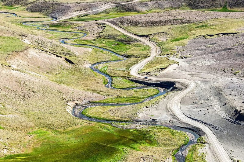 Road Ruta 41, gravel road, lonely car, passing Mt. Cerro Beleadoras, Los Antiguos - Paso Roballo, aerial view, Argentina