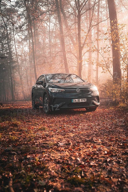 A Volkswagen parked in a quiet forest full of autumn leaves in the early morning fog, electric car VW ID5, Deer Carsharing, Gechingen, Black Forest, Germany