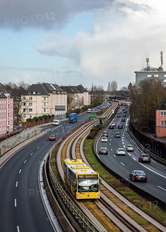 Essen, North Rhine-Westphalia, Germany - Cars and a public bus drive through Essen city centre on the A40 motorway
