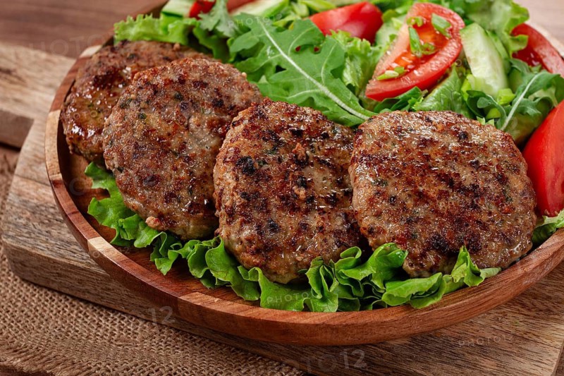 Fried cutlets, mixed minced meat, with vegetable salad, homemade, top view, no people