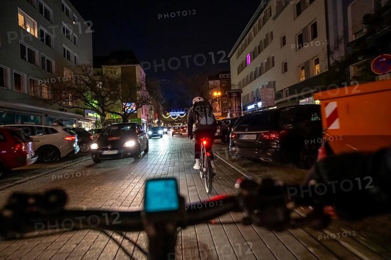 Cycling in the city, in the dark, in the evening, inner-city road, bicycle road, two-wheeler traffic has priority, 30 km/h zone, cyclist perspective, Essen, North Rhine-Westphalia, Germany