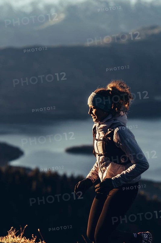 Trail running in autumn on the Jochberg on Lake Walchensee against the wonderful backdrop of the Alps, Bavaria, Germany