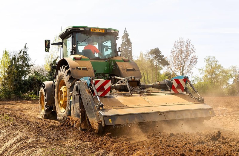 John Deere 8R 340 tractor engaged in field work operating an Agri-World FTC series soil tiller, Shottisham, Suffolk, England, UK