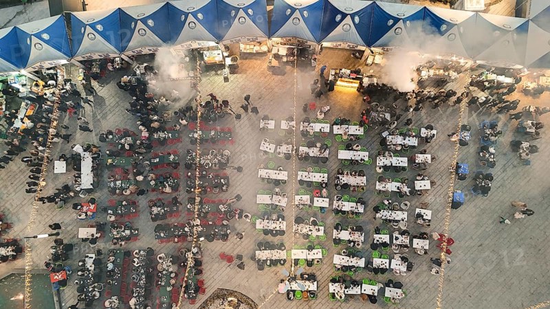 Aerial view captures hundreds of Muslims gathered at long tables for a communal Iftar meal in a festively decorated square outside a large mosque in Gaziantep, Turkey on March 11, 2026, Gaziantep, Turkey
