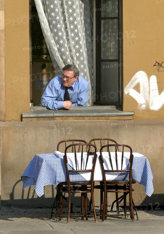 Wroclaw, POL, 30.04.2004 - A man looks out of the window of an inn in Wroclaw, Poland