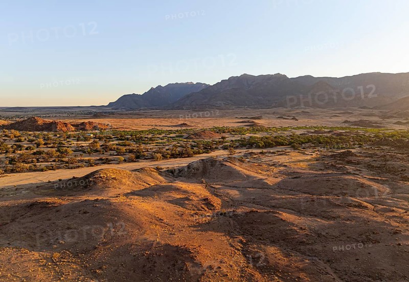 Aerial view, dry riverbed and desert landscape on the Ugab River, behind Brandberg, Erongo, Damaraland, Namibia
