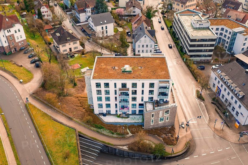 Modern residential building at an urban road junction, from a bird's eye view, Nagold, Calw district, Germany