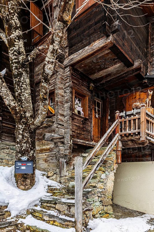 Staircase to a historic wooden house, mountain village of Zinal, Val d'Anniviers, Valais Alps, Canton Valais, Switzerland