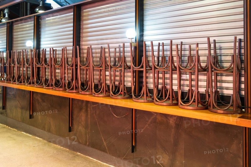 High bar hoickers and closed market stalls in the Mercat de la Boqueria, famous market on the Ramblas in Barcelona, Spain