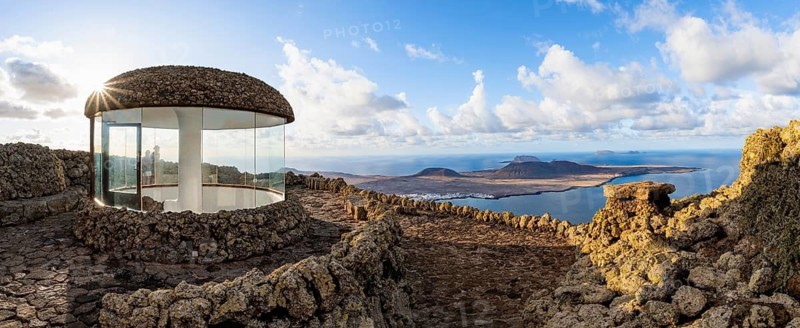 Stairway and viewing platform at the Mirador del Río viewpoint, in the evening light with sun stars, designed by artist César Manrique, view of the island of La Graciosa, Lanzarote, Canary Islands, Spain