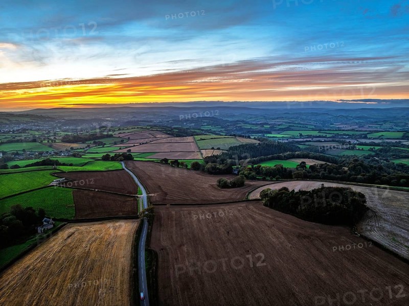 Sunset of Devon Farms and Fields over Berry Pomeroy from a drone, Totnes, England, United Kingdom