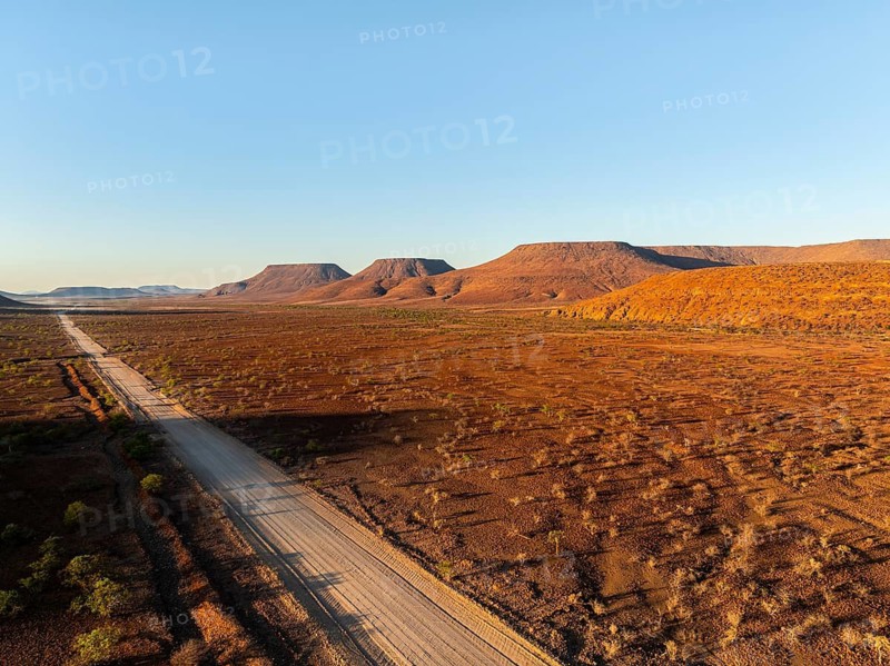 Aerial view, road leading through dry desert landscape, hills in Damaraland, Namibia
