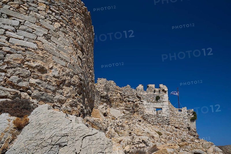 Historic stone wall with Greek flag, typical of Greece, under a clear blue sky, Johanniter Fortress from the 14th century AD, Megalo Chorio Fortress, Kastro, Megalo Chorio, Zero Waste Island, Tilos, Dodecanese, Greek Islands, Greece