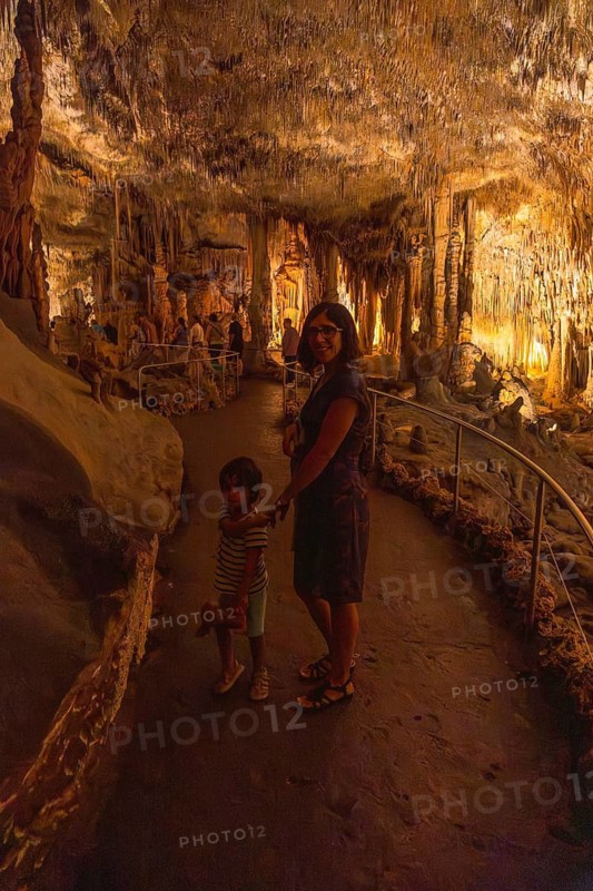Mother and child enjoying a guided tour inside the amazing caves of drach in porto cristo, mallorca, spain