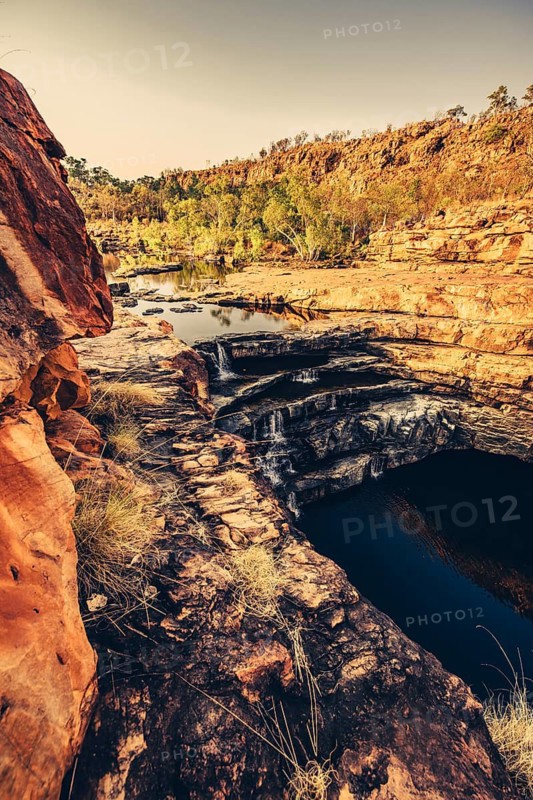 Bell Gorge waterfall, a body of water in north-west Australia in the Kimberley. Sunrise in the outback, Australia