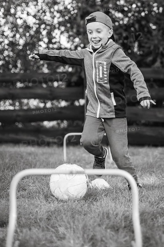 7 year old boy plays football in the garden in Lubin, Poland