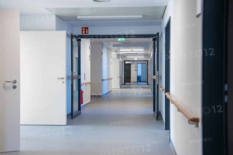 White hospital corridor with opened doors and handrails, new Calw hospital, Germany