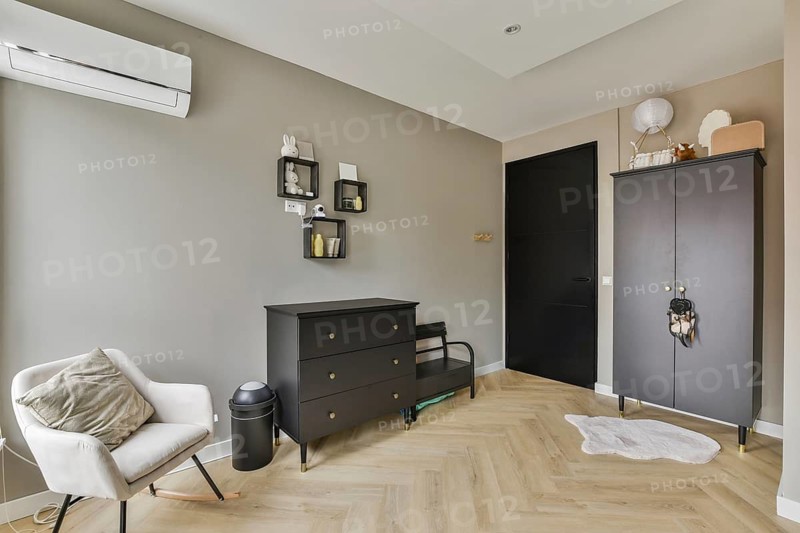 Sleek and stylish living space featuring muted colors, minimalist furniture, and organized decor elements for an elegant atmosphere
