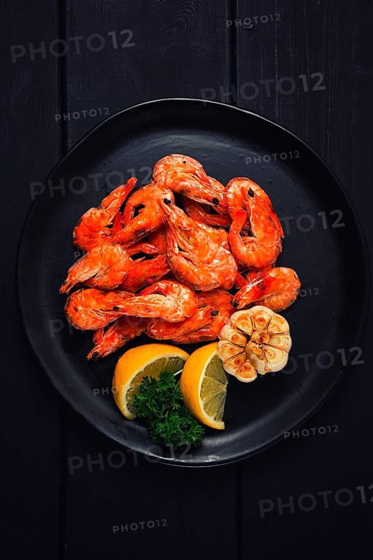 Fried shrimp, on a black background, top view, no people
