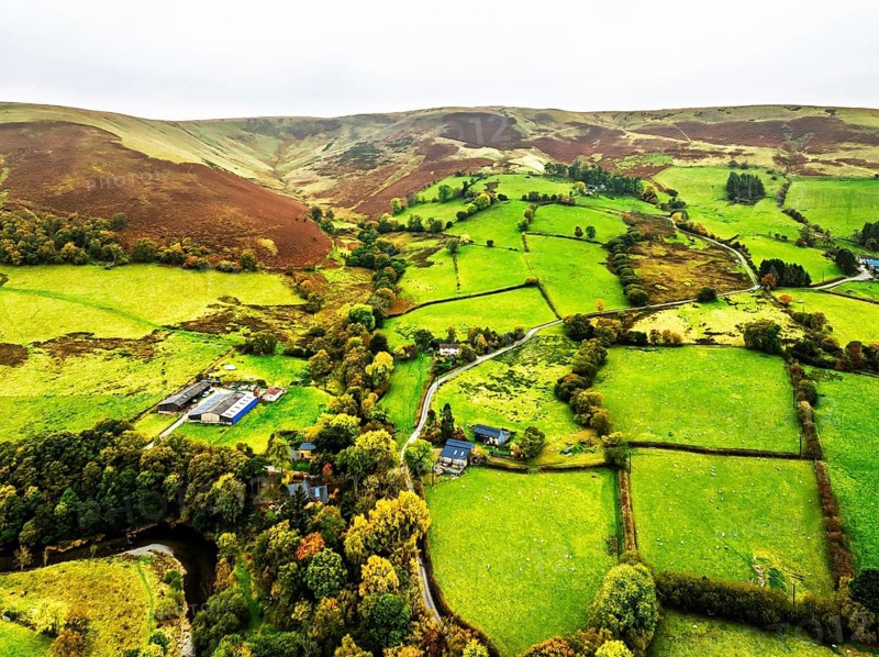 Autumn colours of Farms over River Wye and Road A470 from a drone, Llanidloes, Powys, Montgomeryshire, Wales, UK