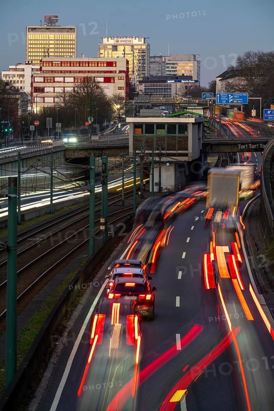 Motorway A40, Ruhr expressway, heavy traffic jam, rush hour, city passage in Essen, skyline of the city centre, underground line between the lanes, Hobeisenbrücke stop, North Rhine-Westphalia, Germany