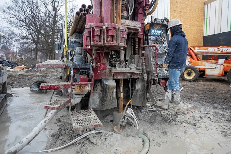 Detroit, Michigan - Workers for Crabtree Drilling drill a series of 500-foot deep wells for a geothermal system. The system will heat and cool a new commercial building housing a public market at the East Warren Development Corporation