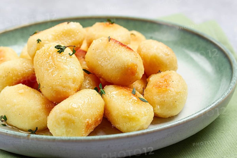 Stuffed gnocchi with cheese, Italian dumplings, garnished with parmesan cheese, no people