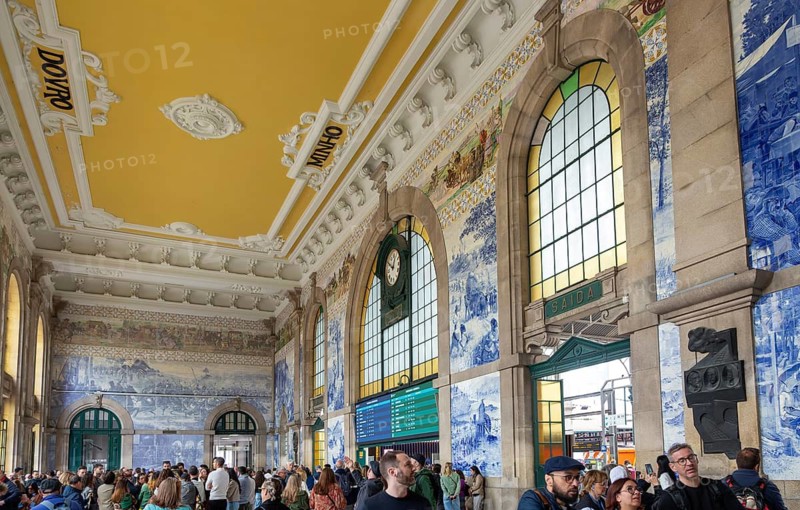 Tour groups viewing historic azulejos tiles, Sao Bento railway station building, city of Porto, Portugal