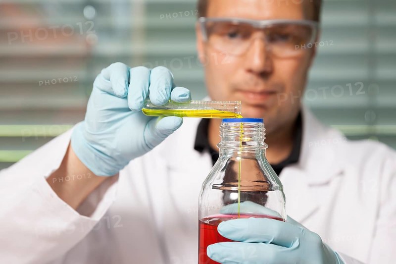 A young laboratory technician experimenting with chemicals, chemist, laboratory, Federal Republic of Germany