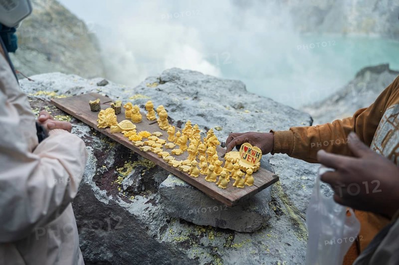 Sulfur souvenirs intricately crafted and displayed on a wooden board at Ijen Volcano in Indonesia. A testament to the natural beauty and creativity of the local artisans