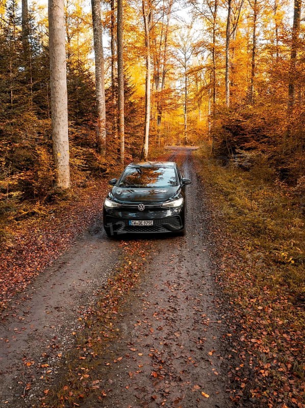 Vehicle on a forest path in a lively autumnal environment, electric car, VW ID5, Gechingen, Black Forest, Germany