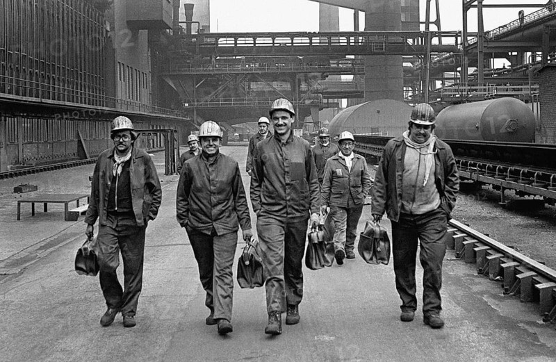 After work, workers from the Zollverein coking plant leave their work gap at the end of the shift. The coking plant was discontinued in 1993. Together with Zollverein Colliery, the former coking plant was declared a World Heritage Site by UNESCO in 2001, Essen, Germany