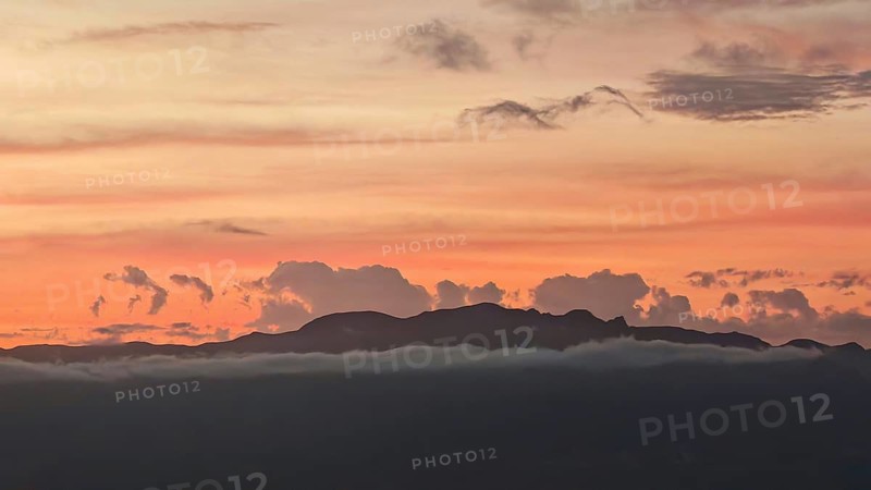 A sunset with orange sky and mountains in the background, Santo Antao mountains in the background, Mindelo, Sao Vicente, Cabo Verde, Cape Verde, Cape Verde
