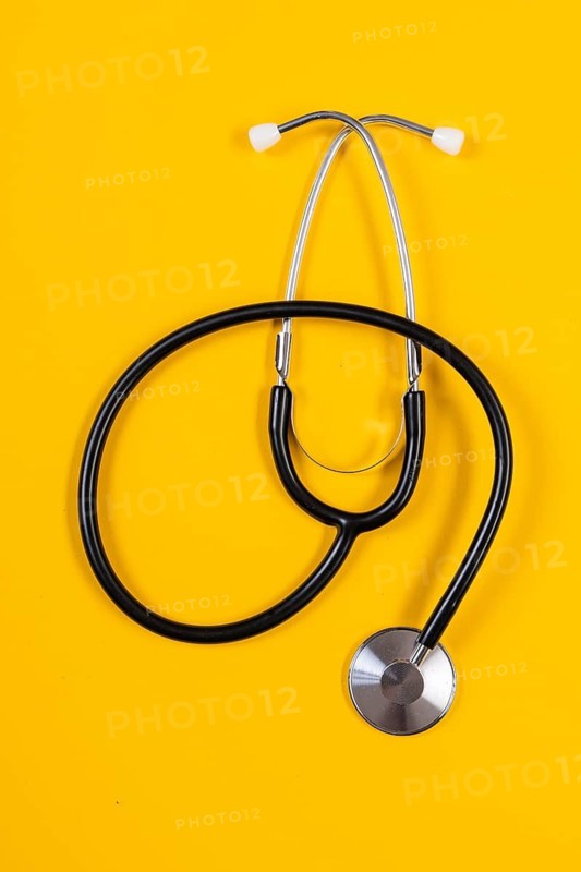 Stethoscope lying in front of a monochrome background