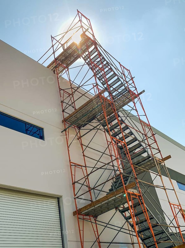Industrial Construction Scaffolding and Ladder Along Building