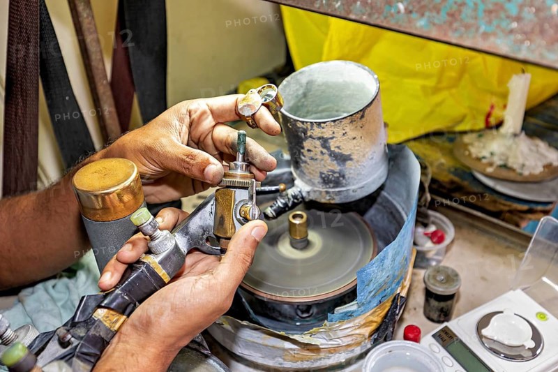 Close-up of hands precisely processing gemstones with a grinding machine, The gemstone cutters in the city of Ratnapura in Sri Lanka
