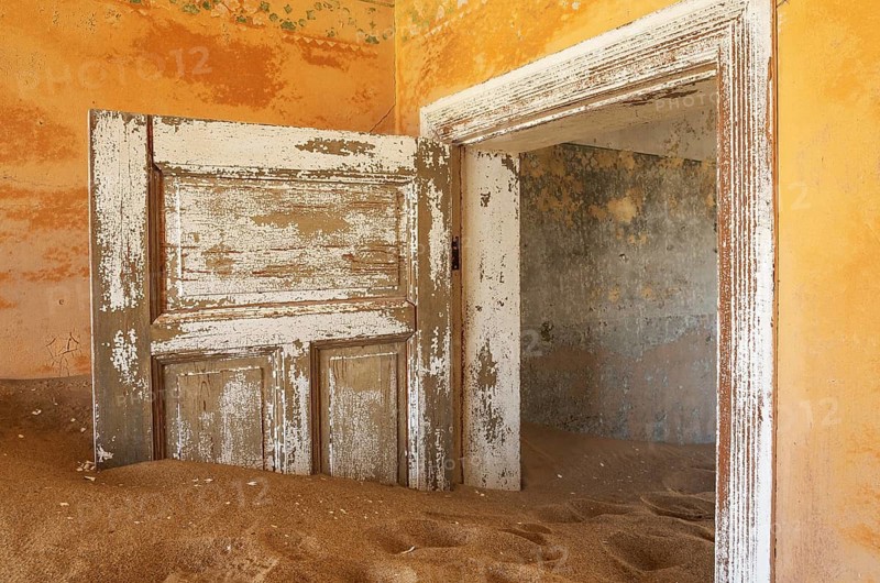 At Kolmanskop, the abandoned ghost town of the diamond days of the early 1900 and of German origin. Inside the restricted Diamond Area east of the coastal town of Lüderitz. Namib Desert, Namibia