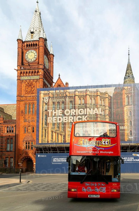 Victoria building clocktower renovation of art gallery, University of Liverpool, England, UK - red double-decker tour bus passing