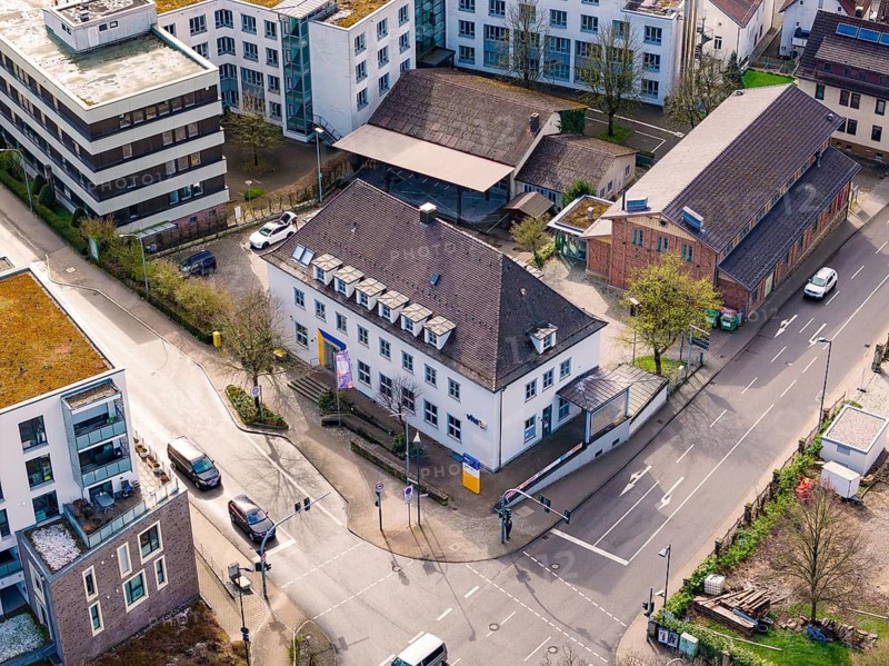 Aerial view of an area with modern buildings, a road junction and parked cars, VHS Oberes Nagoldtal, Nagold, Germany