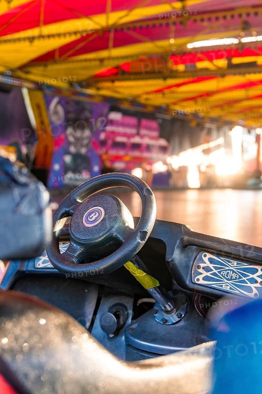 A bumper car steering wheel in a colourful, covered hall at a carnival, Weil der Stadt, Böblingen district, Germany