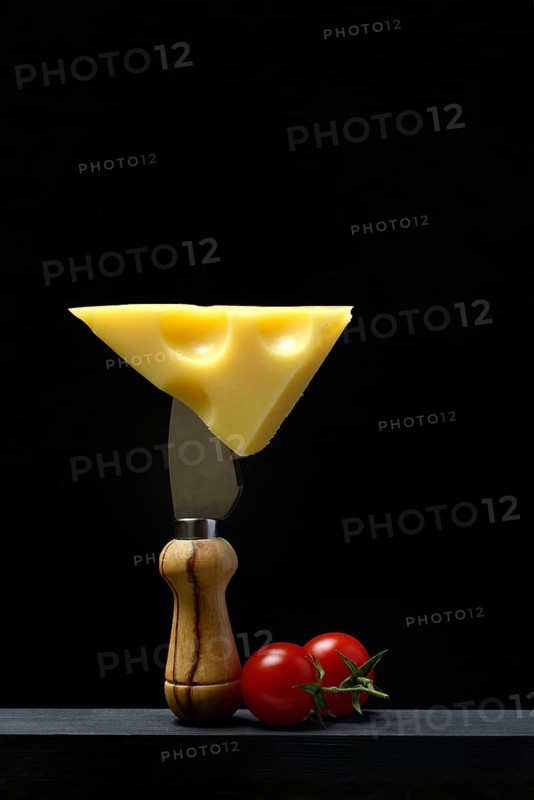 A piece of Swiss Emmental cheese on a cheese knife