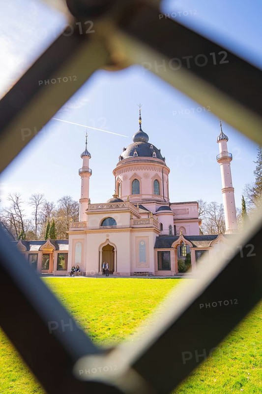 View through a lattice of a mosque with domes and minarets in the sunlight, Mosque, Schwetzingen Palace Gardens, Germany