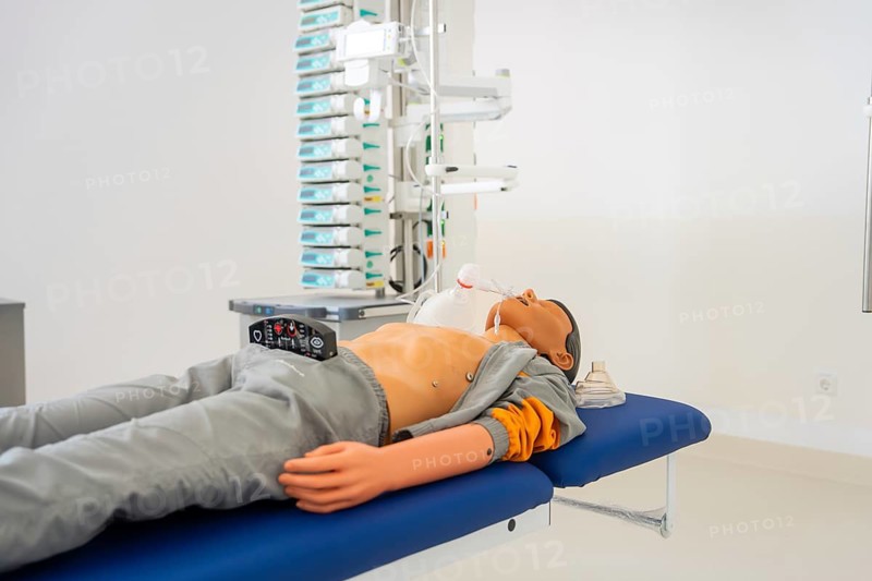 Doll on treatment couch in hospital environment with medical equipment, fire department exercise on blue light day in the new hospital in Calw, Germany
