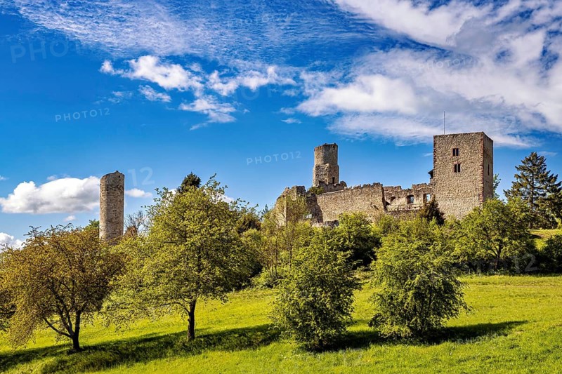 Castle ruins on a hill with a green meadow and a cloudy blue sky, The Brandenburg ruins near Gerstungen in Thuringia in the Werra valley