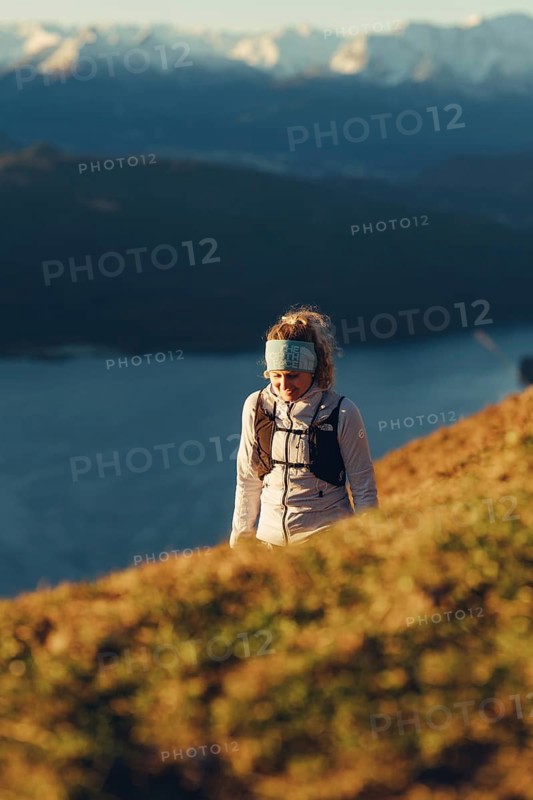 Trail running in autumn on the Jochberg on Lake Walchensee against the wonderful backdrop of the Alps, Bavaria, Germany