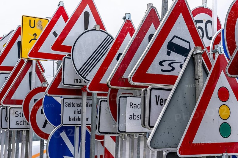 Storage for traffic signs in the yard of a road maintenance department, various signs with commandments and prohibitions, information about dangers, road traffic