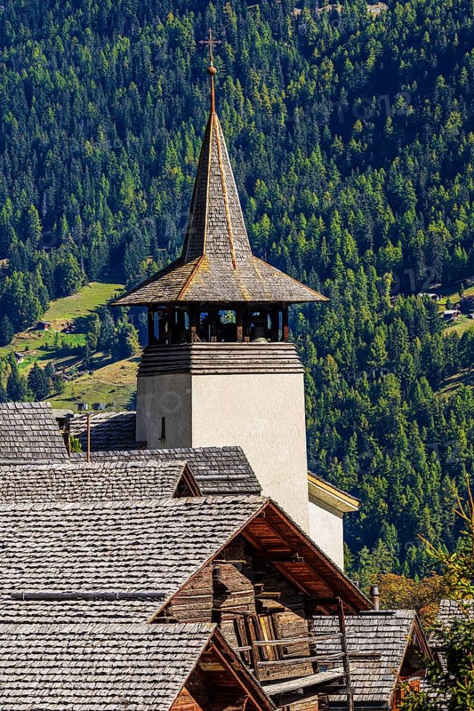 Old wooden houses and the Saint Theodule church in the historic village centre, Grimentz, Val d'Anniviers, Valais Alps, Canton Valais, Switzerland
