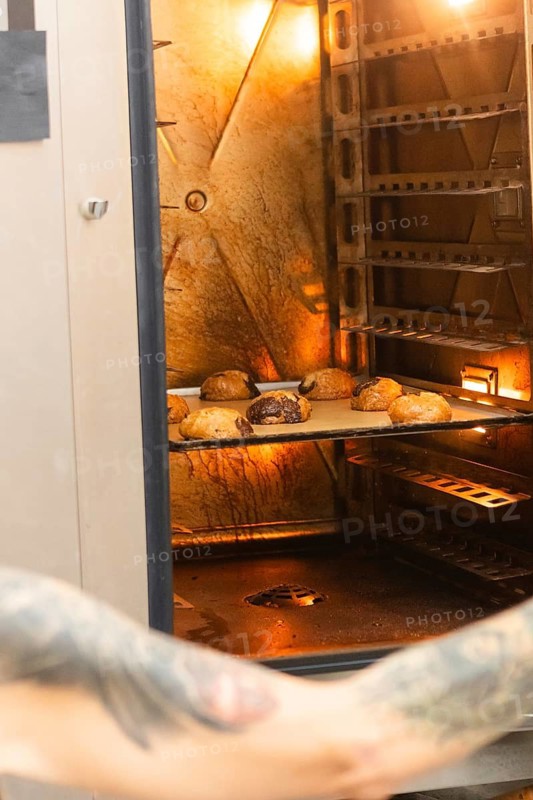 Freshly baked Italian pastries in a warmly lit, rustic oven evoke the authentic charm and delightful aroma of a traditional bakery, highlighting artisanal craftsmanship